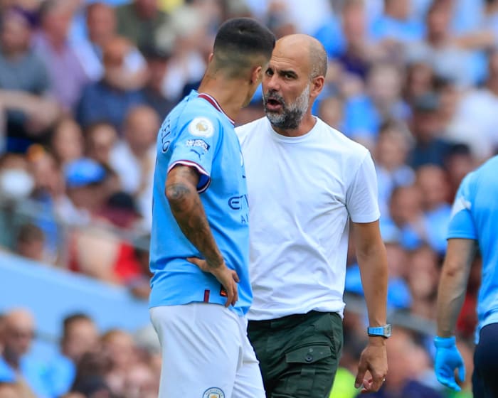 Pep Guardiola (right) pictured speaking to Joao Cancelo during Manchester City's game against Bournemouth in August 2022